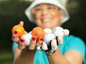 Mature lady with golf balls